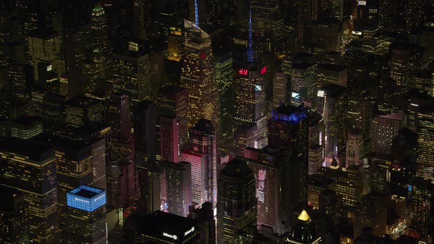 Skyscrapers are lit up with neon lights at night