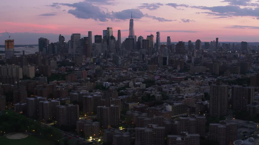 Lights are on in a city at almost nightfall
