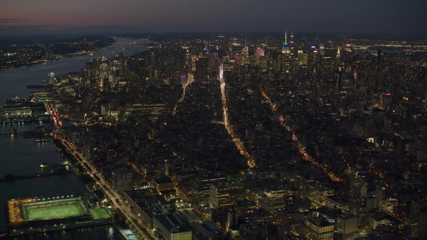 Lines of traffic light up city intersections at night
