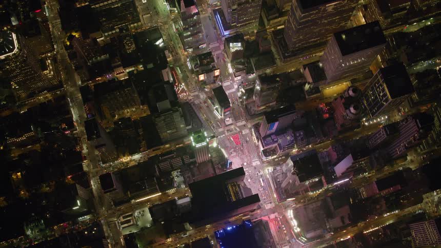 Traffic passes through city intersections at night