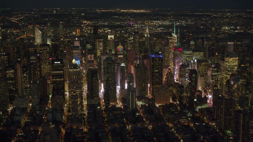 City streets are lit up in a grid in a city