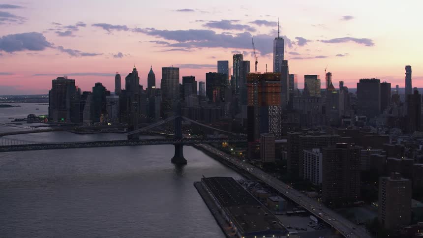 An aerial view of buildings at sunset in a city