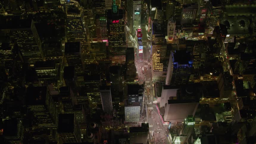 A city street is full of traffic on a dark night