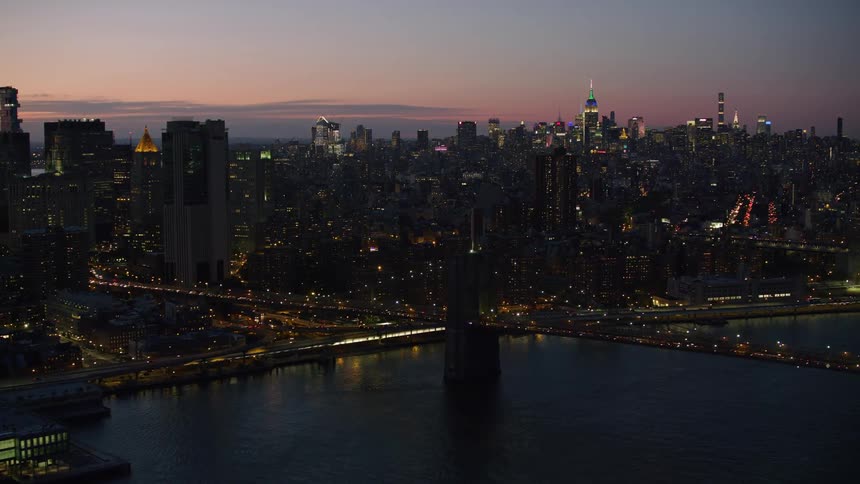 The new york city waterfront and skyline building illuminated at dawn
