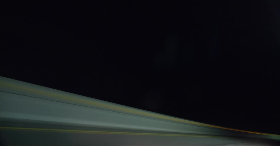 Vehicles travel on the highway at night