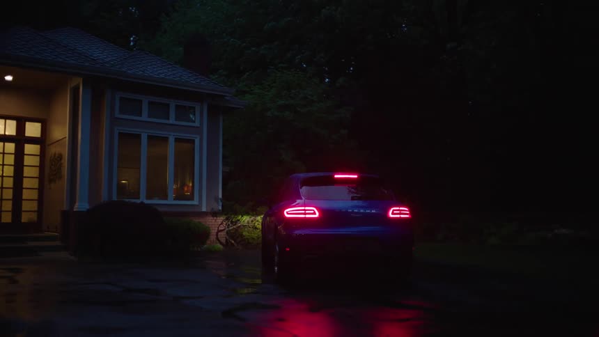 A vehicle pulls up to the front of a house and parks