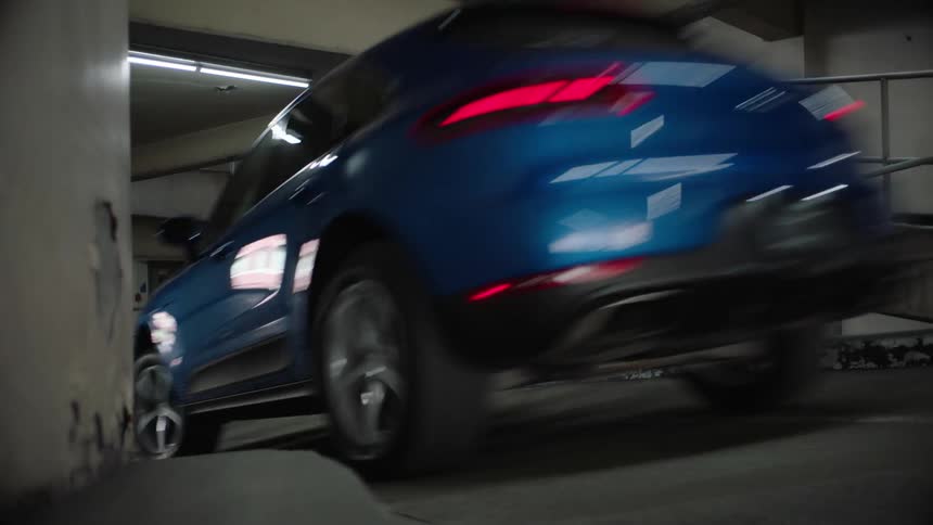 A person is driving a vehicle out of a parking ramp