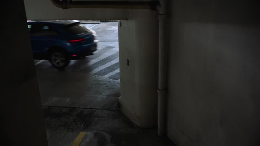 A car driving through a public parking garage