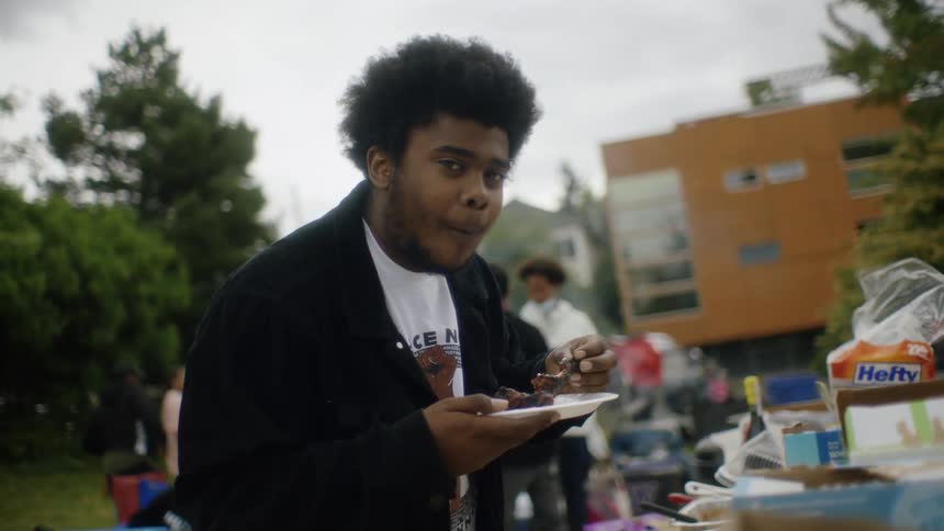 Young man eating ribs on a barbecue outdors