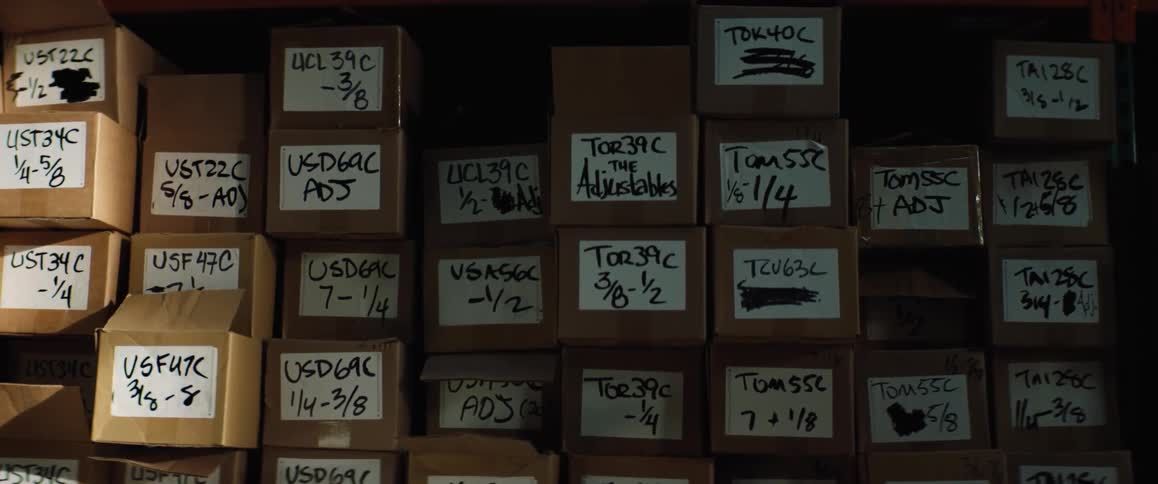 Boxes are stacked and labeled in a storage room