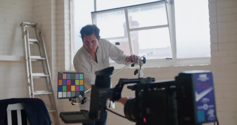 A man is setting up to film