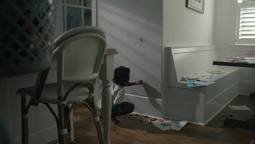 A view of a child coloring on the walls