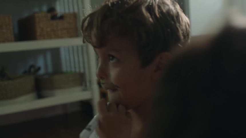 Two kids coloring on their faces with markers