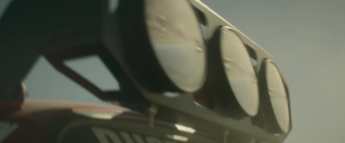 All terrain vehicle with roof mounted lights drives on the desert at daytime