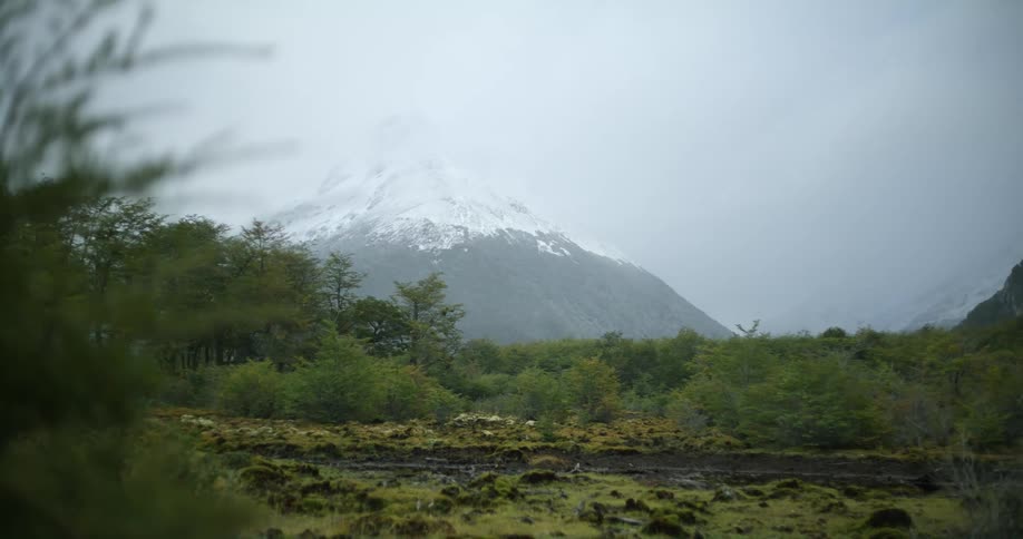 The mountain is behind the field