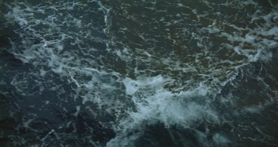 Rough water is splashing and foaming as it waves and rolls