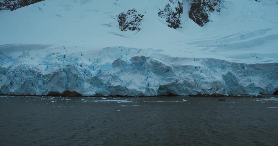 The coast of a frozen landmass in the evening