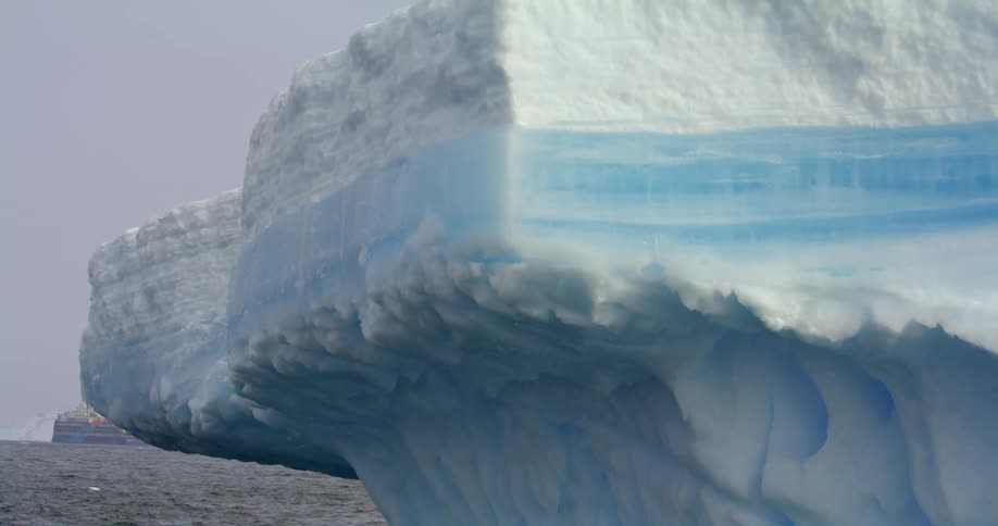 A group of peopl over an inflatable raft in the ocean close to the arctic mountains