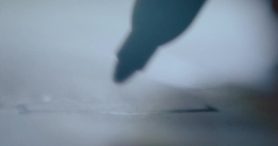 A person draws with marker on paper