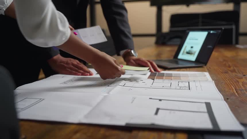 Two people review possible color choices while planning the design of the interior of a building