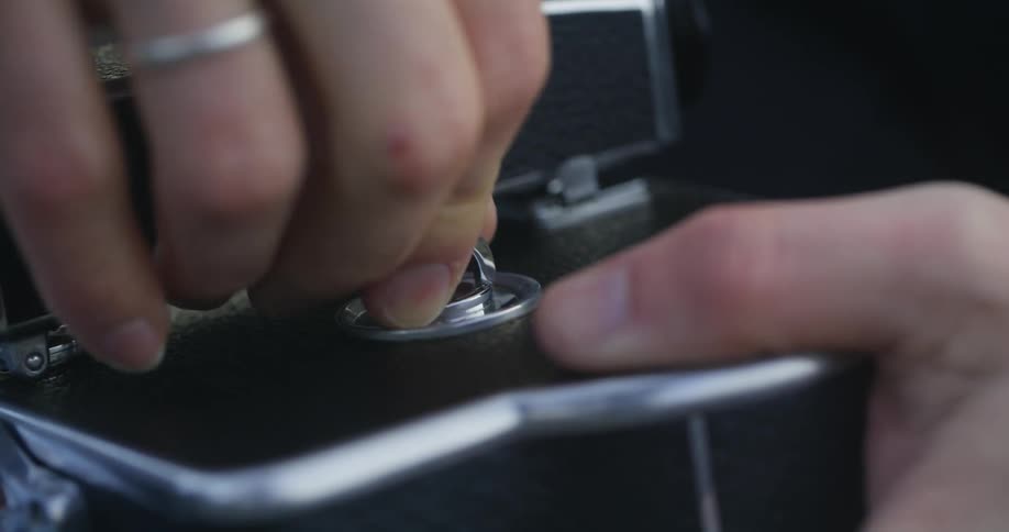 A person putting together a camera