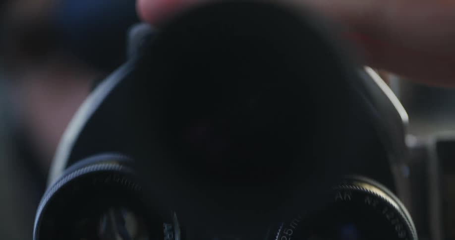 A person turns the lens on the camera