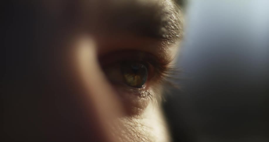 Close up of the eyes and forehead of a man outdoors at evening