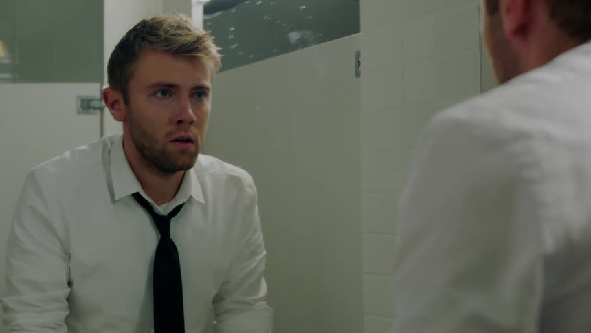 A man is upset while looking in the mirror