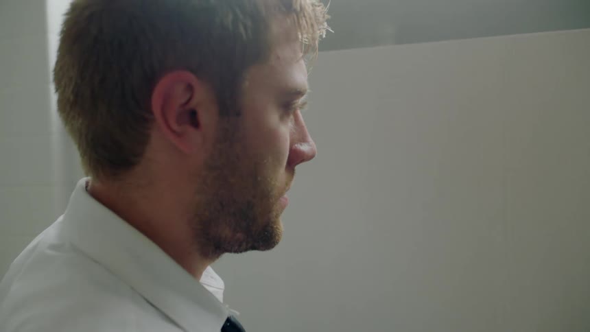 A man searches for people in the bathroom