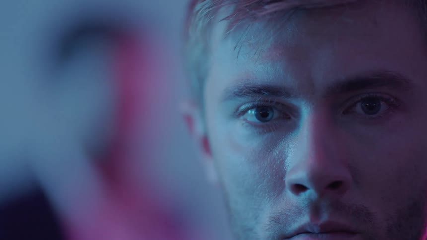 Close up view of a mans face is displayed on camera