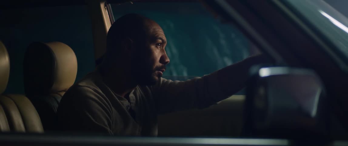 A man is sitting in the driver seat of the car