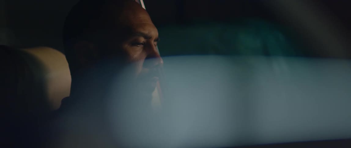 Man sits in drivers side of car and looks around