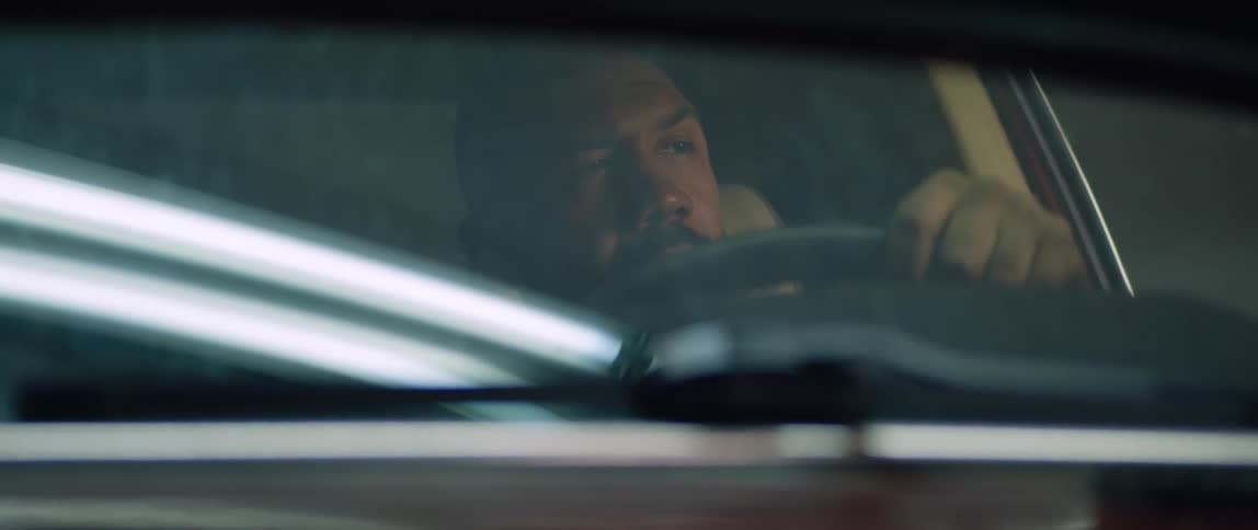 Man sits in car holding steering wheel and thinking
