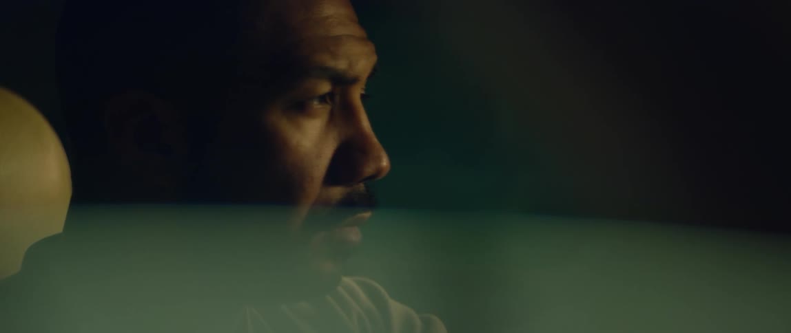 A man looks around as he sits in a car