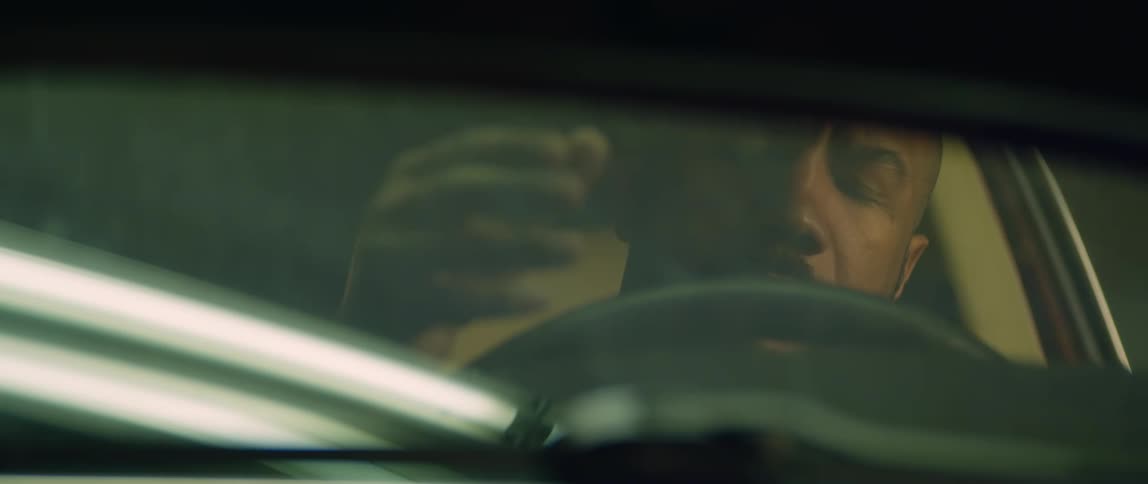 A man cracks his knuckles while sitting in his car