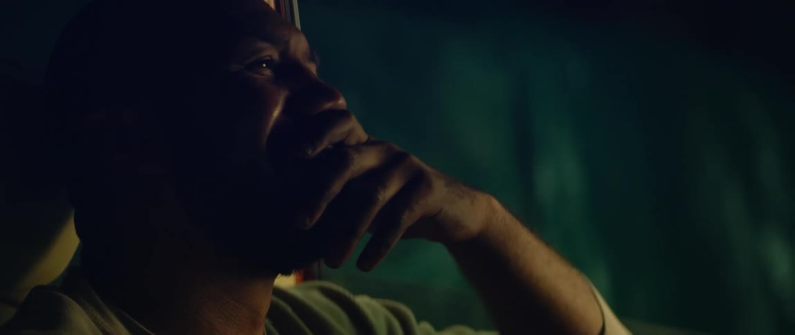 A man reminisces about the past while sitting in his parked car