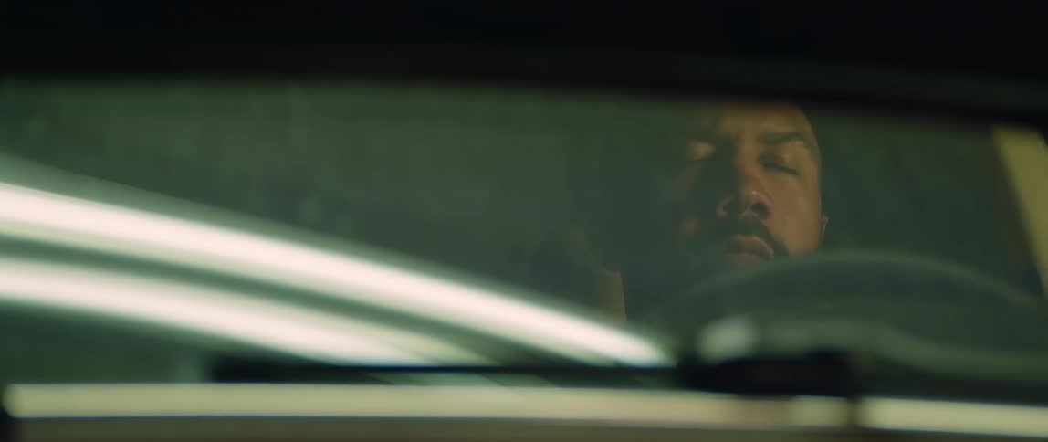 A man falls asleep behind the wheel of his car