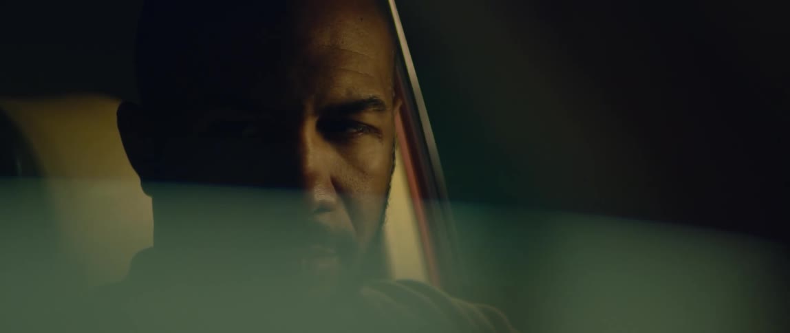 A man looks around the inside of his car as he sits in the drivers seat