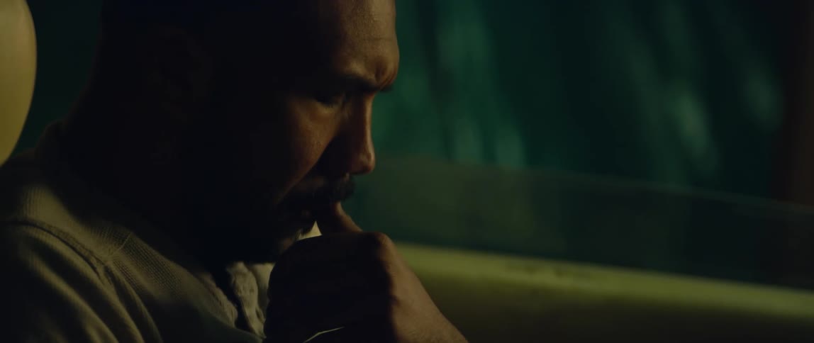 A man sitting in the driver seat of a car deep in thought