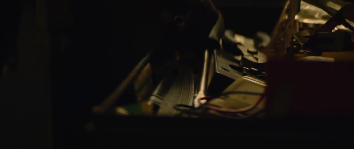 Close up of a man taking a tool out of a tool box