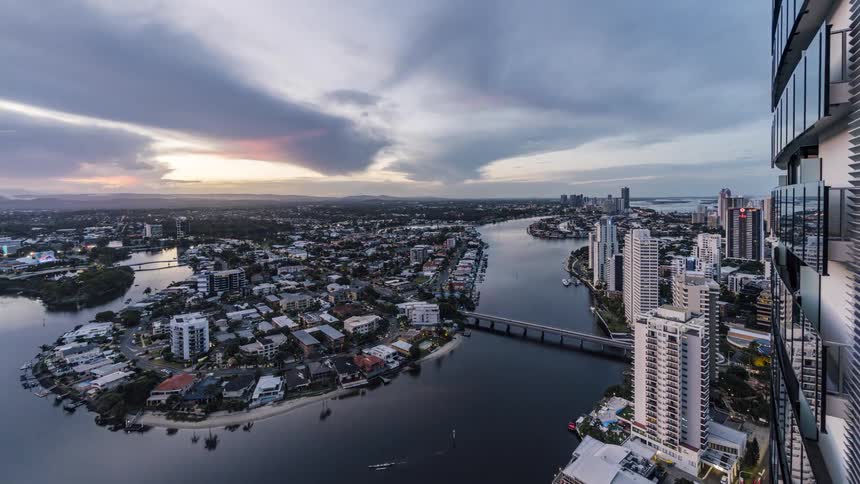 Time lapse view of a city near the coast is displayed