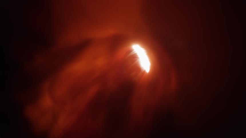 A bright white light shines inside and casts red shadows