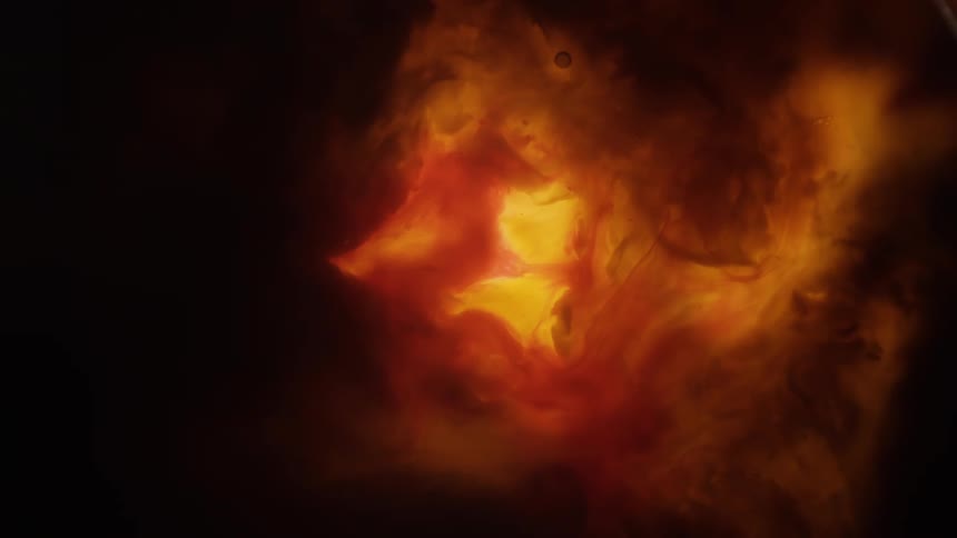A light glows behind an orange fluid