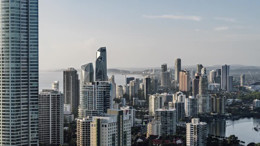 Tall buildings in a metropolis on the coast at sunrise