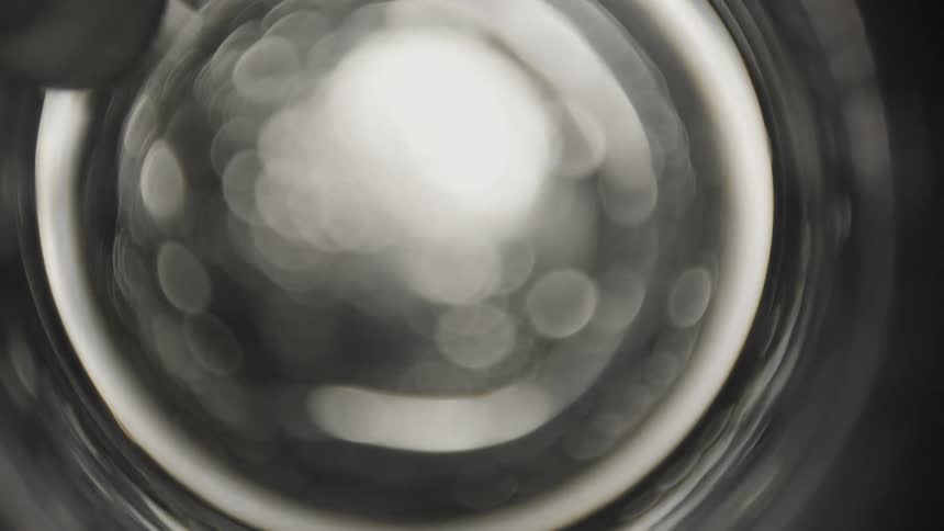 Bubbles are reflecting light as they rapidly move downward