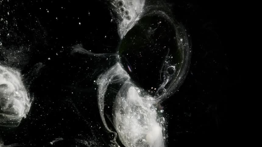 A bubble forms and distorts before disappearing in space