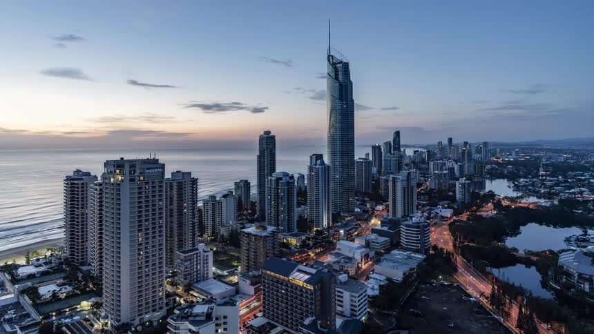 The sun rises over the coast of a metropolis
