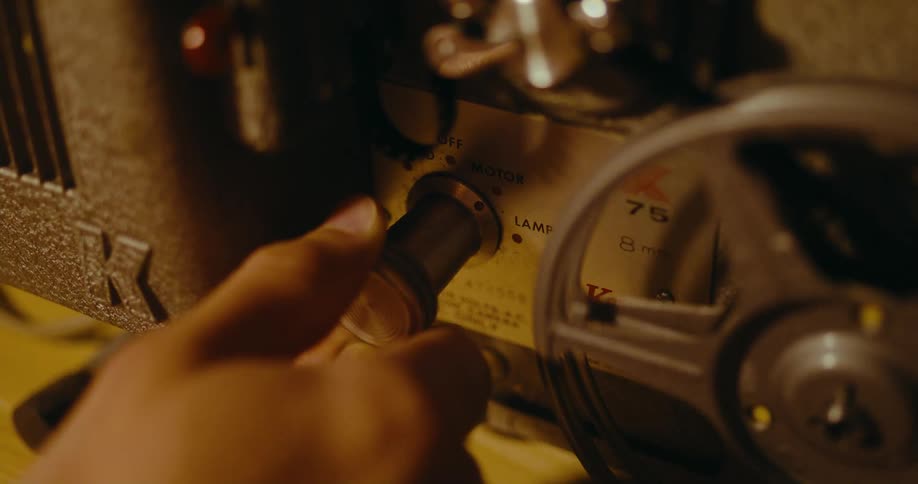 A person turns the knob on an old piece of electronic equipment