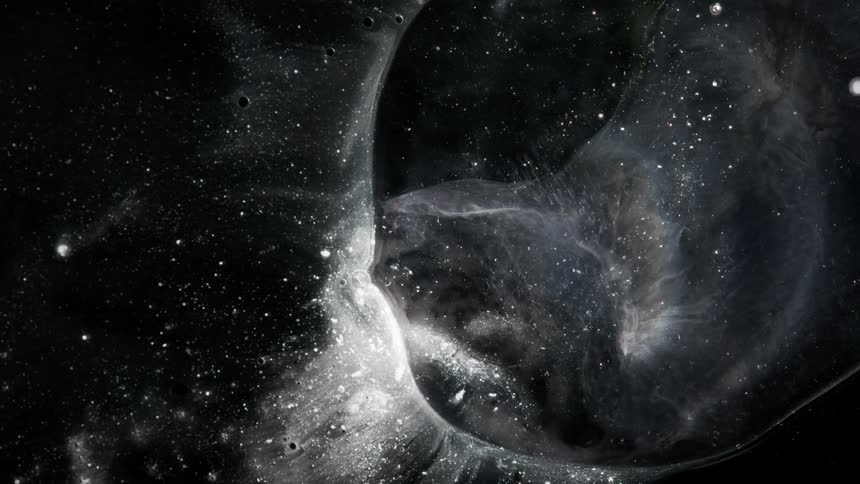 Lights twinkle and clouds move among spheres in the darkness