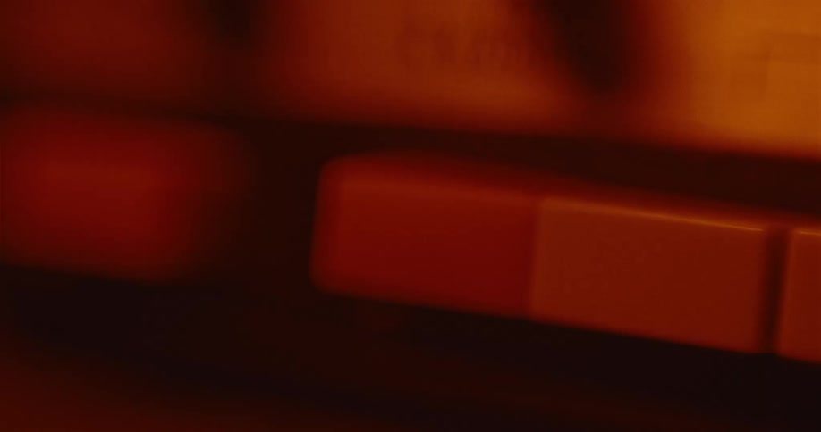 Red light shines as a persons finger pushes a button
